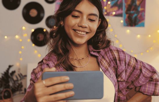 Teen girl taking a selfie in front of a phone