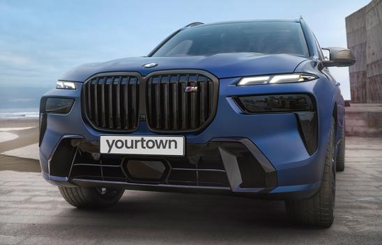 Close up of the front of a Blue BMW X7 with yourtown replacing the number plate 