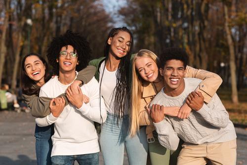 Positive Group Of Young People Having Fun At Public Park