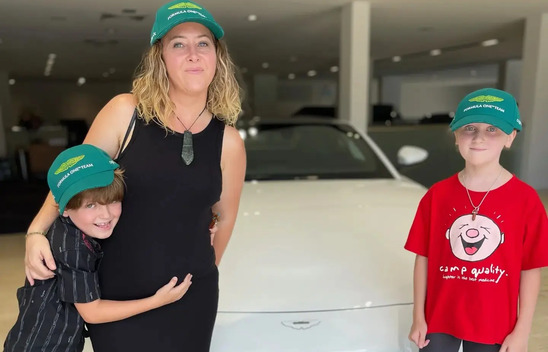 Car Draw 1141 winner with her two young kids in front of their new car - approved