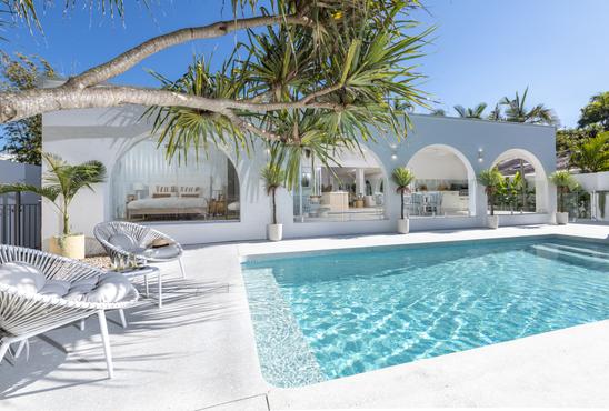 Shot of a pool facing a toward the alfresco of a house  