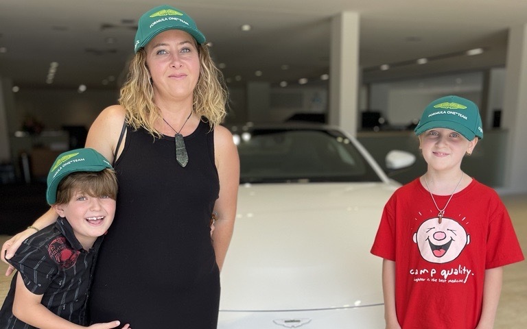 Winner of Prestige Car Draw 1141 in front of her new car with her two children