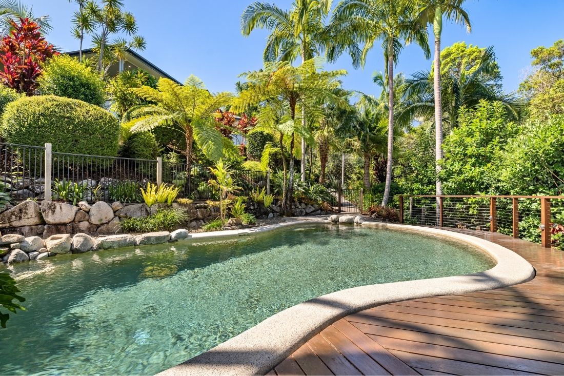 Pool surrounded by lush gardens