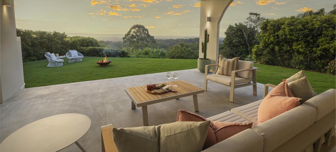 Alfresco area with outdoor seating overlooking fire pit and then to views over Buderim, Sunshine Coast at dusk.
