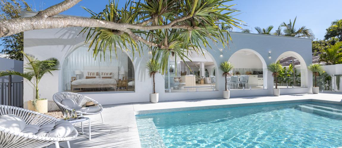 Shot of a pool facing a toward the alfresco of a house  